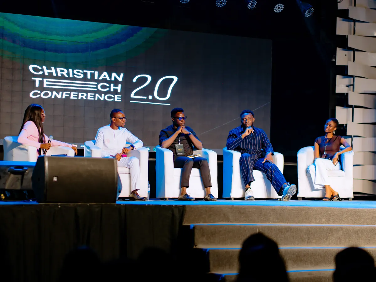 Six people seated on white chairs on the CTC 2.0 stage during a panel.